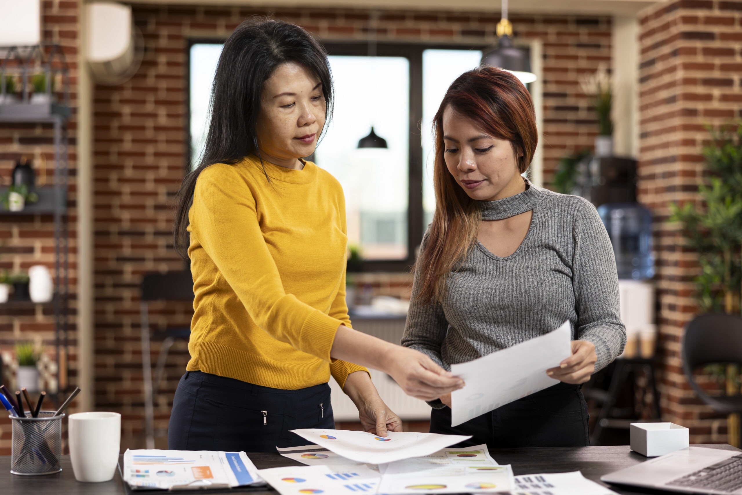 Female researchers holding documents