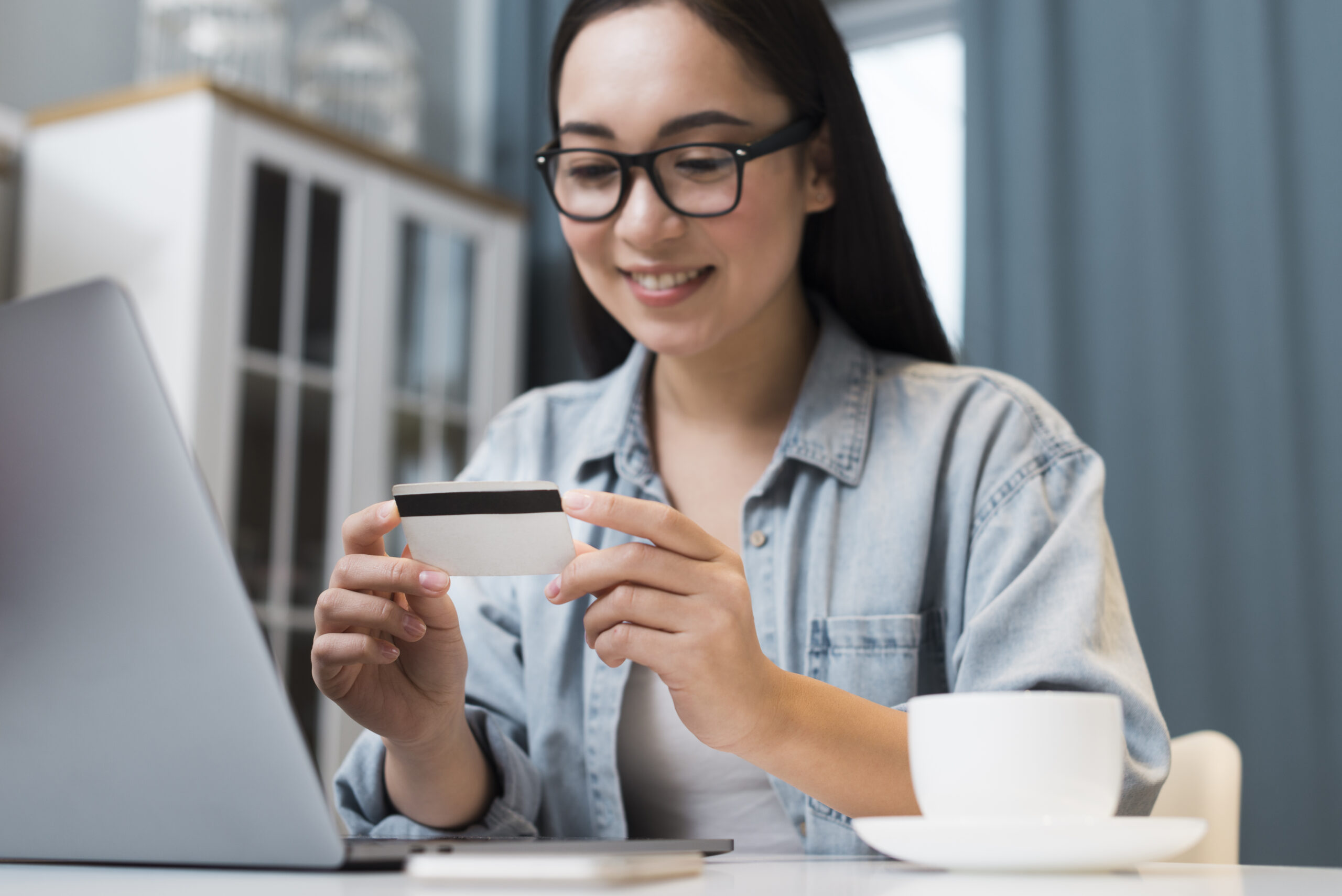 Woman smiling while holding credit card